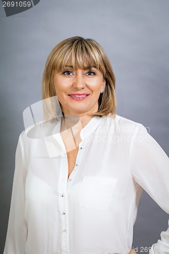 Image of Smiling confident middle-aged blond woman