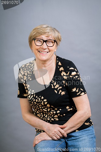 Image of Attractive blond senior woman wearing glasses