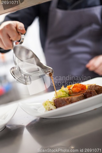 Image of Chef plating up food in a restaurant