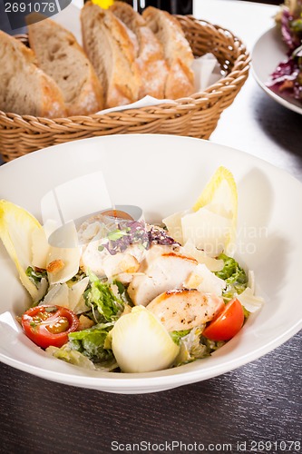 Image of tasty fresh caesar salad with grilled chicken and parmesan 