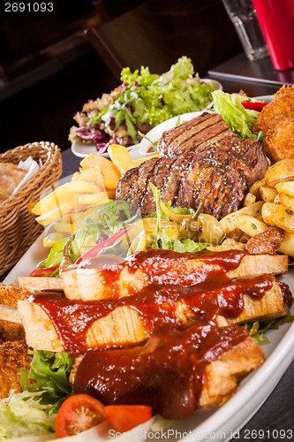 Image of Platter of mixed meats, salad and French fries