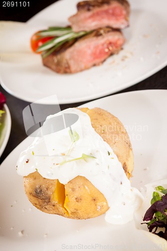 Image of Baked jacket potato with sour cream sauce