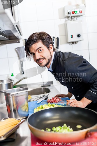 Image of Chef cooking a vegetables stir fry over a hob