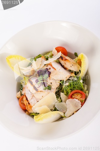 Image of tasty fresh caesar salad with grilled chicken and parmesan 