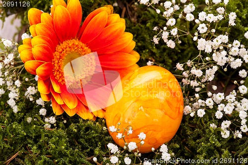 Image of Vivid orange Easter egg with a gerbera and rose