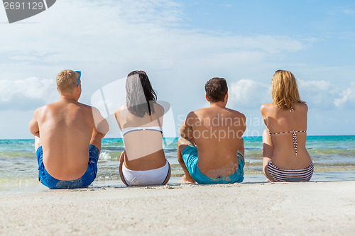 Image of young happy friends havin fun on the beach