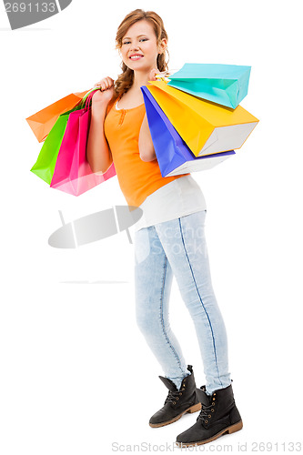 Image of attractive young woman with colorful shopping bags