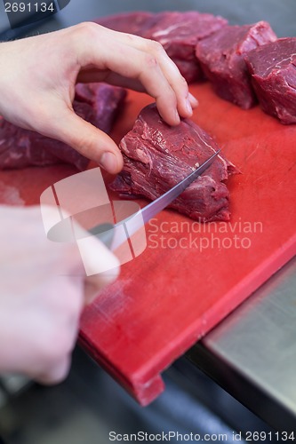 Image of Chef or butcher dicing meat