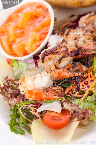 Image of Grilled prawns with endive salad and jacket potato