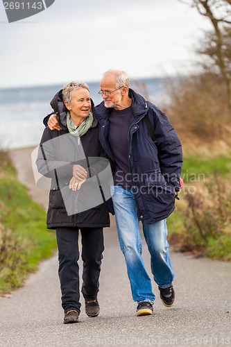 Image of happy mature couple relaxing baltic sea dunes 