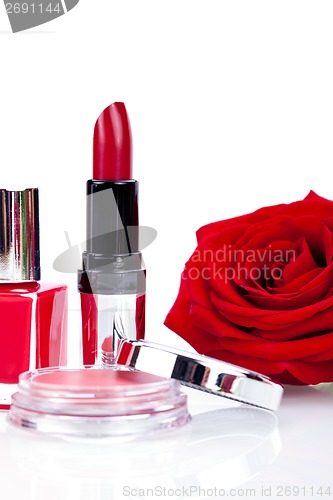 Image of Fashionable cosmetics with a fresh red rose