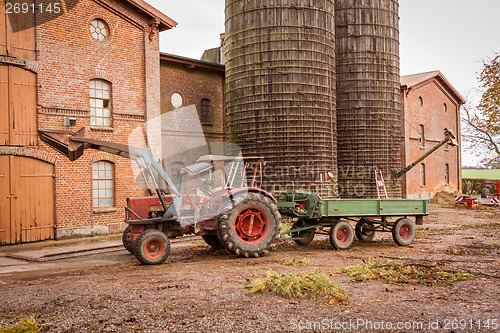 Image of Tractor and trailer in a farmyard