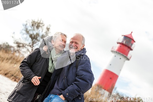 Image of happy mature couple relaxing baltic sea dunes 