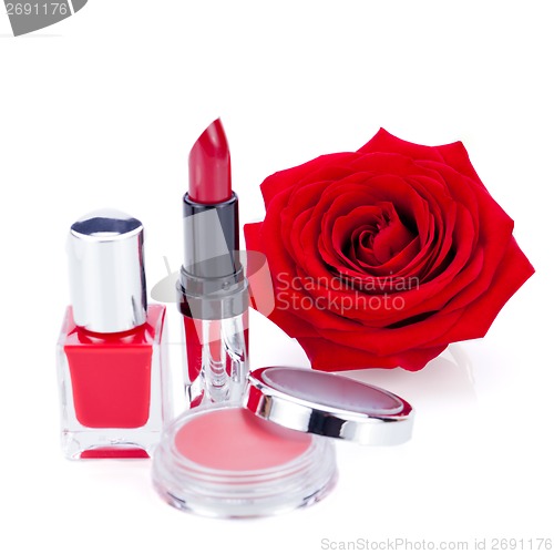 Image of Fashionable cosmetics with a fresh red rose