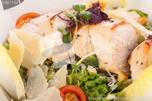 Image of tasty fresh caesar salad with grilled chicken and parmesan 