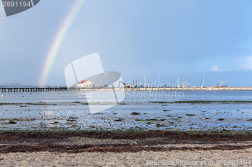 Image of Rainbow over tidal mud flats at the coast