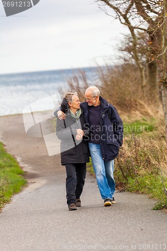 Image of happy mature couple relaxing baltic sea dunes 