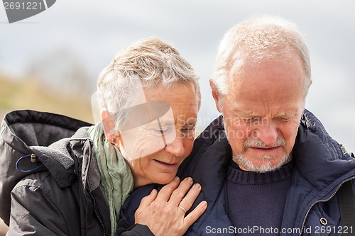 Image of happy elderly senior couple walking on beach