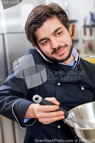 Image of Chef taking a call on his smartphone