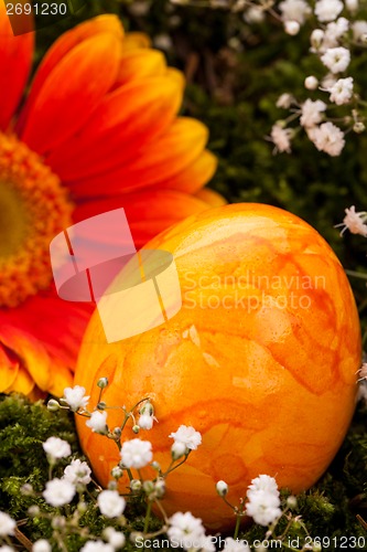 Image of Vivid orange Easter egg with a gerbera and rose