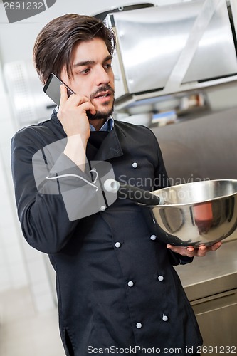 Image of Chef taking a call on his smartphone