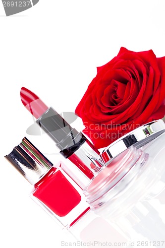 Image of Fashionable cosmetics with a fresh red rose