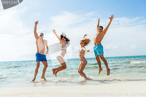 Image of young happy friends havin fun on the beach