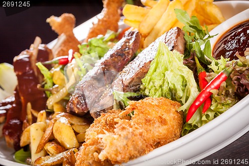 Image of Platter of mixed meats, salad and French fries