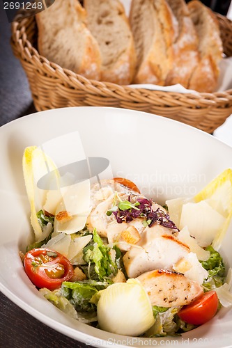 Image of tasty fresh caesar salad with grilled chicken and parmesan 