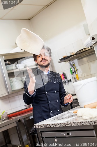 Image of Chef tossing dough while making pastries