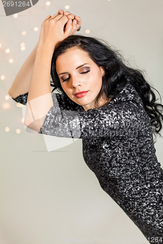 Image of Beautiful dreamy woman with glitter dress dancing