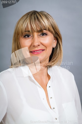 Image of Smiling confident middle-aged blond woman