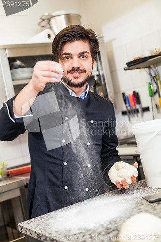 Image of Chef tossing dough while making pastries