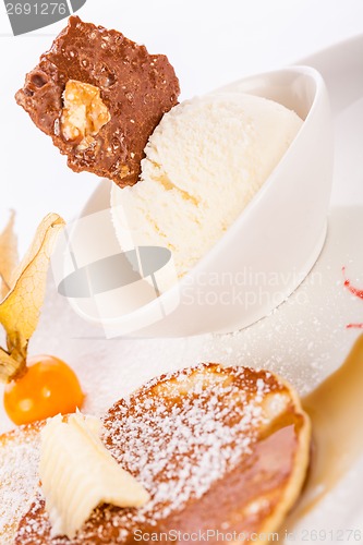 Image of tasty sweet pancakes with vanilla icecream and topping