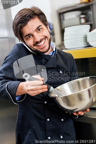 Image of Chef taking a call on his smartphone