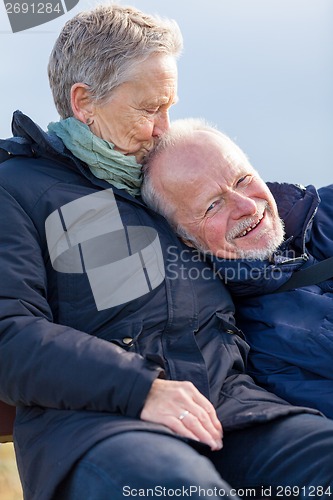 Image of happy senior couple relaxing together in the sunshine