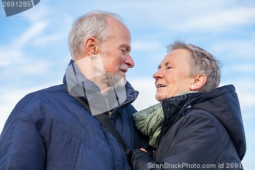 Image of Elderly couple embracing and celebrating the sun