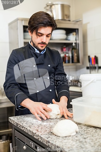 Image of Chef tossing dough while making pastries
