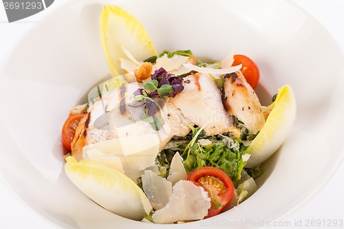 Image of tasty fresh caesar salad with grilled chicken and parmesan 