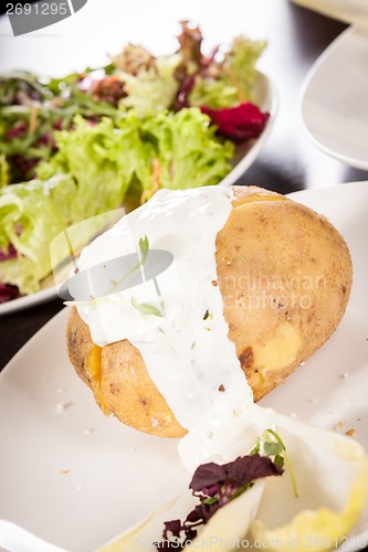 Image of Baked jacket potato with sour cream sauce