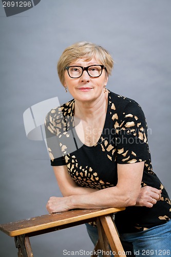 Image of Attractive blond senior woman wearing glasses