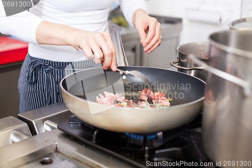 Image of Chef or braising meat in a frying pan