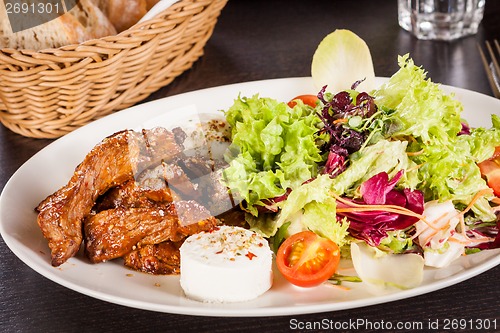 Image of grilled beef stripes fresh salad and goat cheese