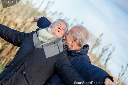 Image of Elderly couple embracing and celebrating the sun