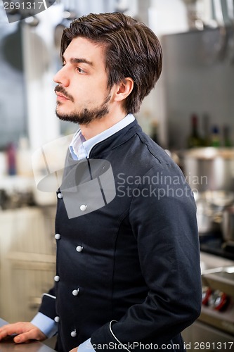 Image of Chef stirring a huge pot of stew or casserole