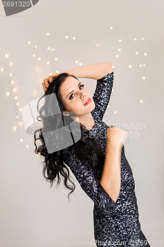 Image of Beautiful dreamy woman with glitter dress dancing