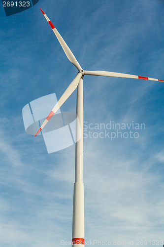 Image of Wind turbine against a blue hazy sky