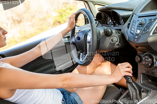 Image of Vivacious beautiful woman driver in her car