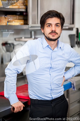 Image of Friendly attractive man in a commercial kitchen