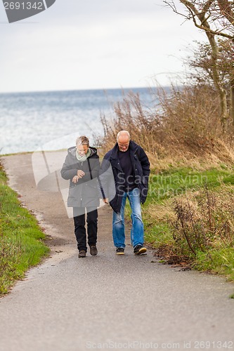 Image of happy mature couple relaxing baltic sea dunes 